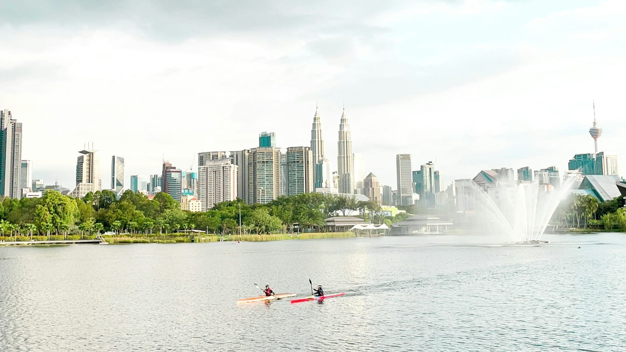 a couple of people riding on top of a boat in a lake